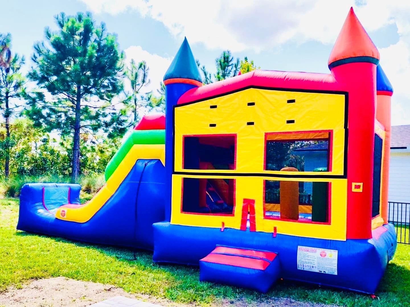 Colorful Surf and Slide bounce house combination with attached slide